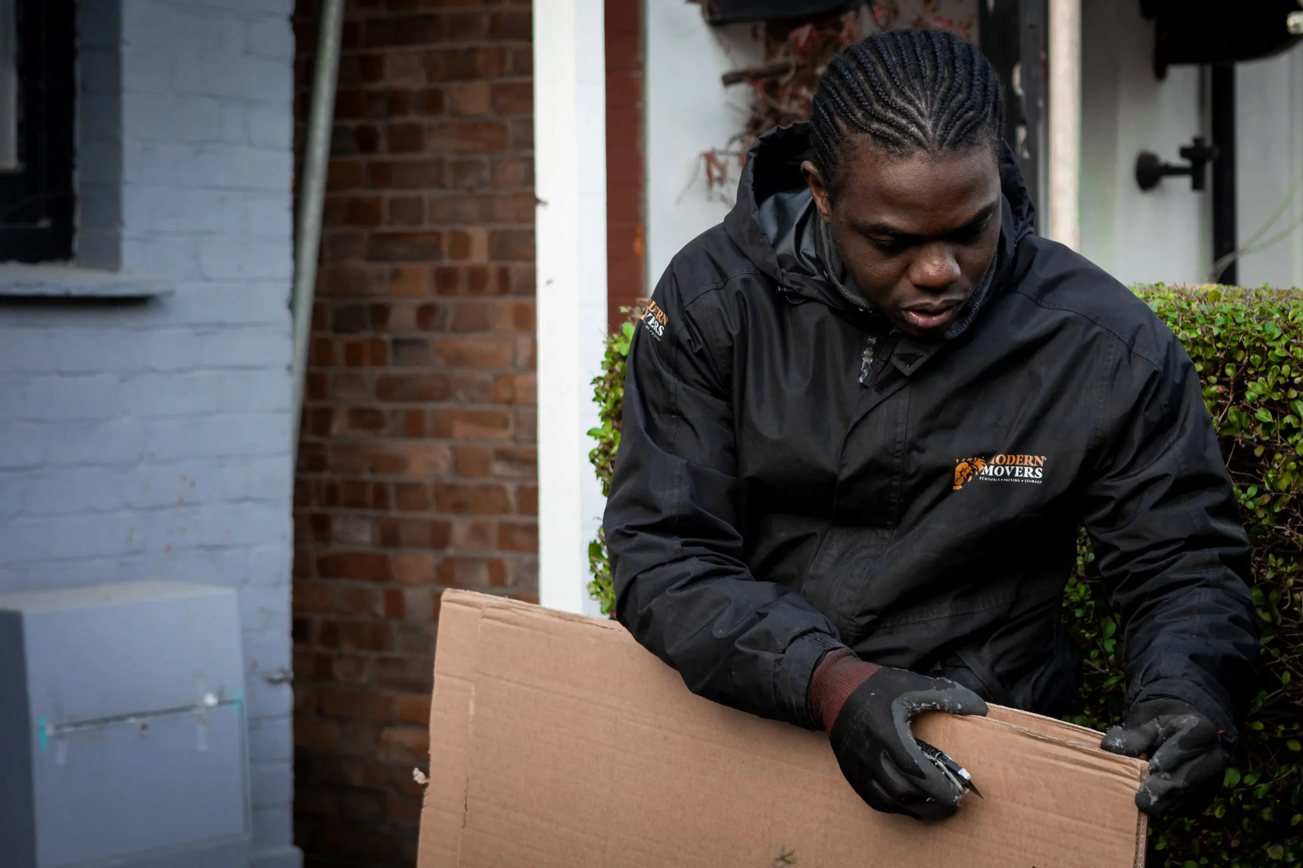 Modern Movers packing up a living room during a house removal in Whitechapel,Tower Hamlets